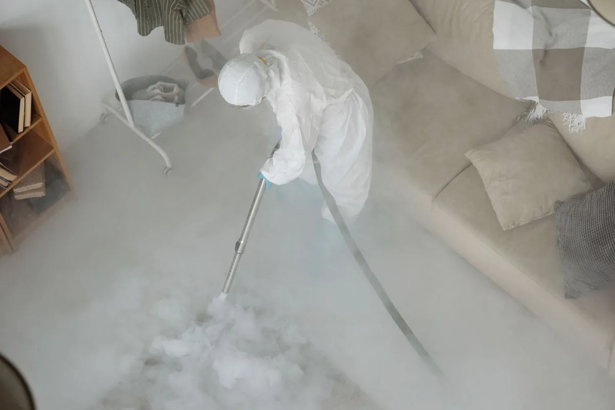 Biohazard cleanup technician in protective equipment, Mississippi State, MS